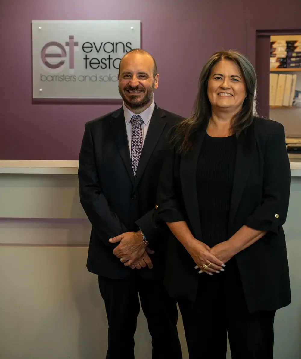 Phil and Lauri in front of ET Law signage