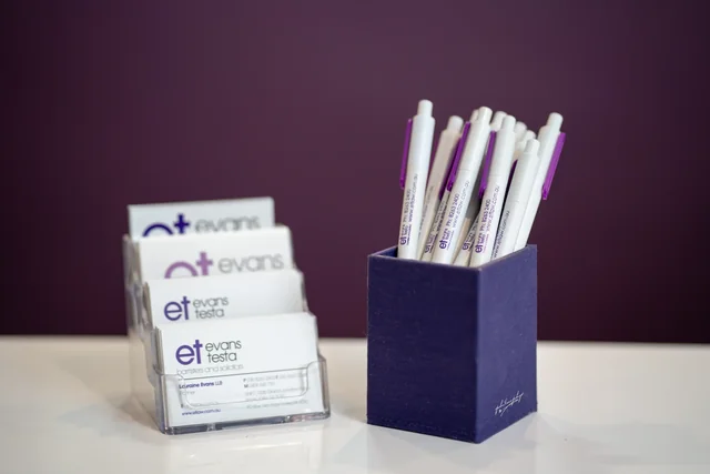 Evans Testa business cards and branded pens.