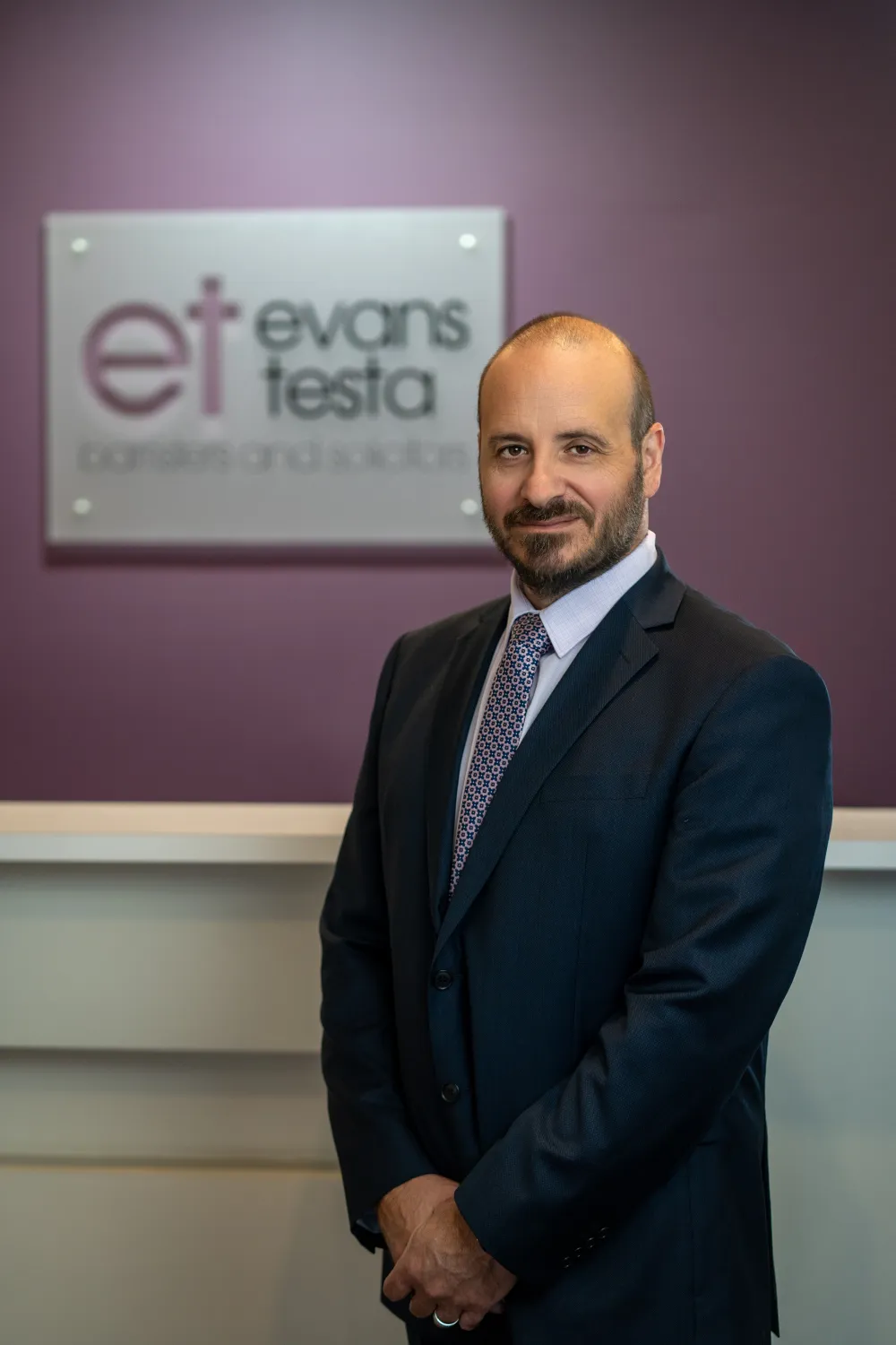 Phil Testa in front of ET Law signage
